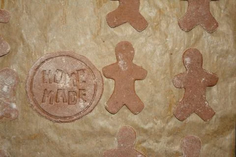Human and round shape gingerbreads on brow paper during preparation. Home mad Stock Photos