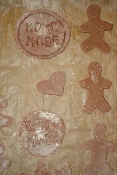 Human and round shape gingerbreads on brow paper during preparation. Home mad Stock Photos