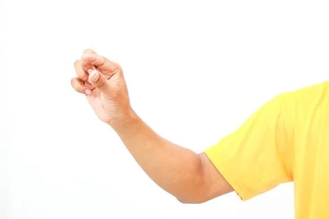 A human arm extends reaching with curled fingers in a vibrant yellow shirt 스톡 사진