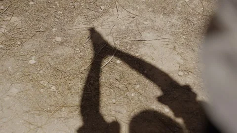 Human arm shadow reaches upward clasped hands Vídeo Stock 339074806