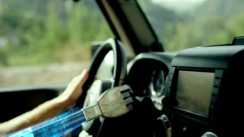 Human with artificial robotic arm holding steering wheel and driving vehicle. Stock-Footage 336266105