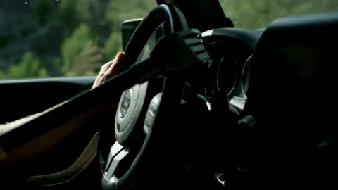 Human with artificial robotic arm holding steering wheel and driving vehicle. Stock-Footage 336266122