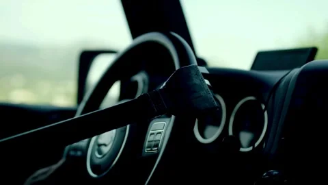 Human with artificial robotic arm holding steering wheel and driving vehicle. Видео 336266138