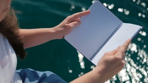 A human being with a hat opens and closes the notebook clean the water Stock Footage 74730767