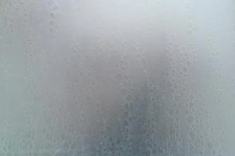 Human body through a shower screen with drops on a light background Stock Photos