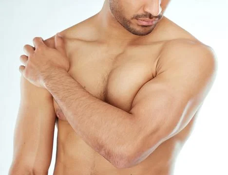 The human body is a work of art. a man touching his shoulder against a studio Stock Photos