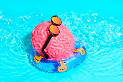 Human Brain Character Floats in the Pool 스톡 사진