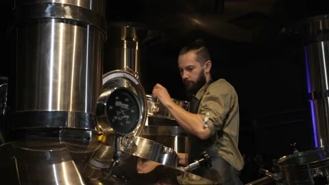 A human brewer checks the fermentation process of the ingredients Stock Footage 220067058