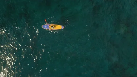 Human controls a kayak into the emerald Water of the Ocean. Stock Footage 146831455