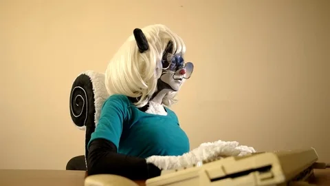 Human dressed as a skunk working on an old computer Video stock 79812528
