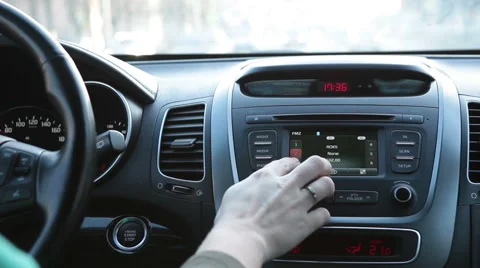 Human driving car and pushing buttons on radio, dashboard and wheel Stock Footage 48361707