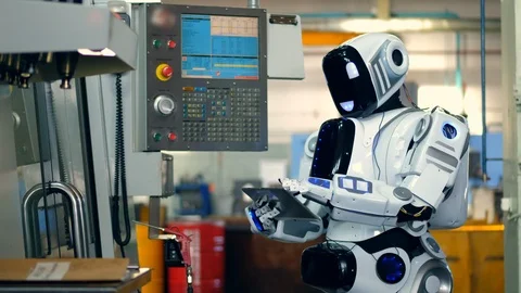 Human-like droid is operating computerized equipment Video stock 107922990
