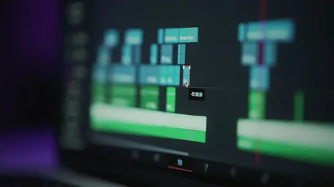 A human editor uses a laptop to creatively create a video clip. Makes color Stock Footage 232317862