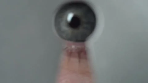 The human eye approaches the keyhole. Stock Footage 154078945