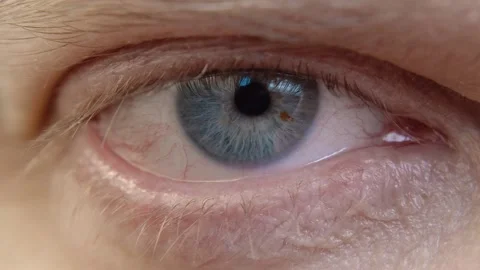 Human eye iris opening pupil close up slow motion. Stock Footage 168313570
