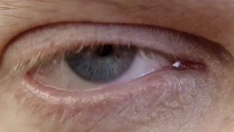 Human eye iris opening pupil close up slow motion. Stock Footage 168313573