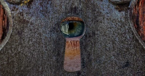A human eye looking through a keyhole. Stock Footage 83877161