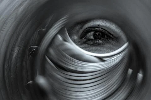 The human eye looks through the spring spiral Stock Photos
