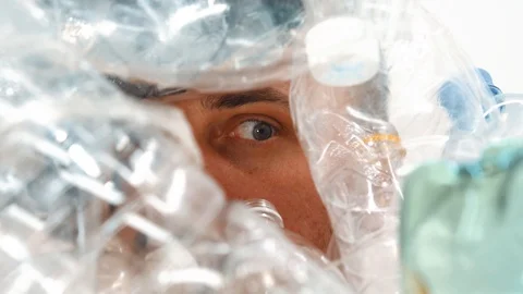 Human eye in a pile of plastic Stock Footage 125329486