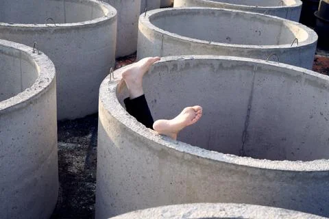 Human feet on the background of concrete structures outdoors Stock Photos