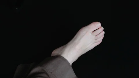 Human Female Foot on Black Background Stock Footage 121108232