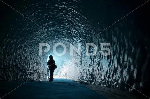 Human figure silhouette inside ice cave Stock Photos