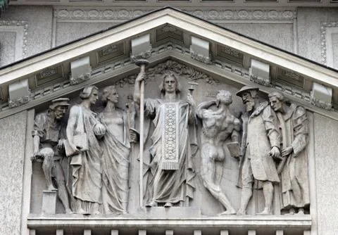 Human figures on a classical facade decoration Stock Photos