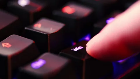 Human finger is clicking on the WIndows button on the computer keyboard, cl.. Stock Footage 303707304