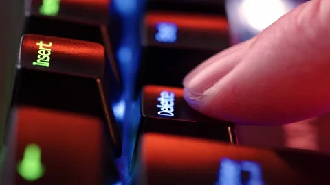 Human finger fast clicks on the Delete key on the computer keyboard, close .. Stock Footage 234792880