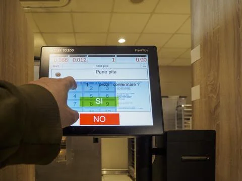 Human finger interacts with touchscreen interface displaying food selection.. Stock Photos