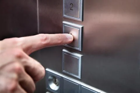 Human Finger Pressing Elevator Button Stockfoto's