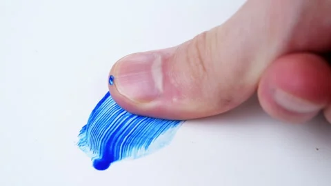 Human finger spreading blue paint in white surface Video stock 255886443