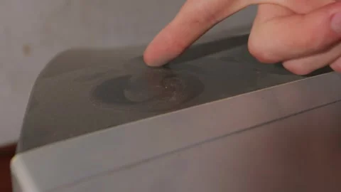 Human Finger Swiping Through Thick Dust Layer on Old Electronic Device Stock Footage 335634515