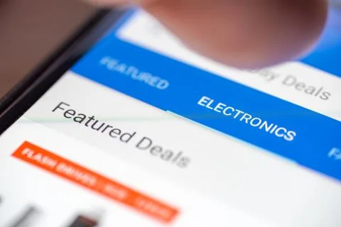Human finger thumb over Electronics category button link on shopping app on Foto stock