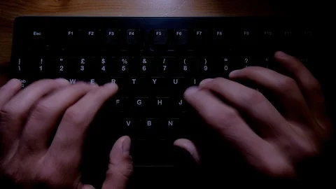 Human fingers In The Dark Working on Writing and typing on a job pc Keyboard Stock Footage 107437983