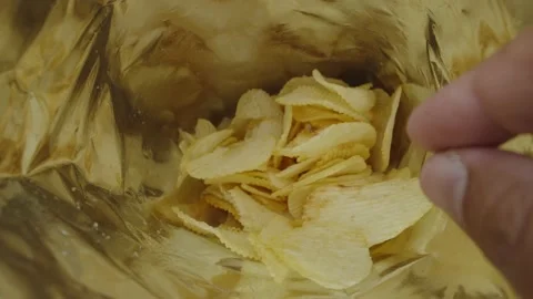 Human fingers making a decision to takes potato chips or not. Stock Footage 235182703