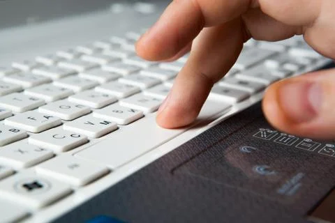 Human fingers on the notebook keyboard Stock Photos