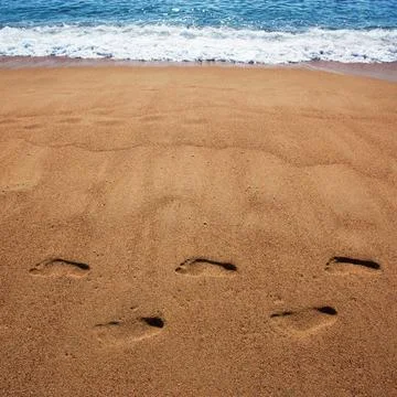 Human foot prints in the sand Stock Photos
