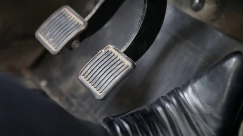 Human foot in Shoe, alternately presses on the gas pedal and brake Stock Footage