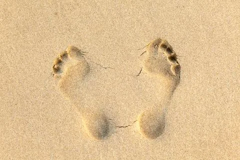Human footprints in the sand at the beach Stock Photos
