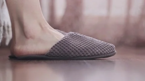 Human gets up at bed and wears slippers. Stock Footage 168751082