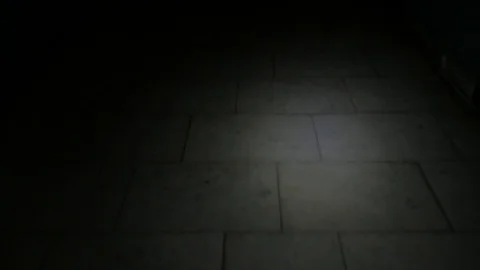 Human goes inside the dark corridor holding lantern and looking for the exit. Stock Footage 125170739