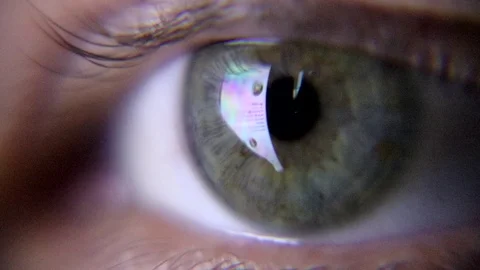 Human green eye looking at the screen of the smartphone. Video stock 94180666