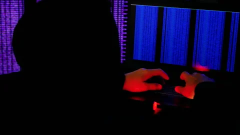 Human hacker is involved in breaking into security system.Programmer at computer Stock Footage 159033780