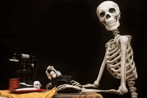Human Halloween Skeleton at the table with typwriter Stock Photos