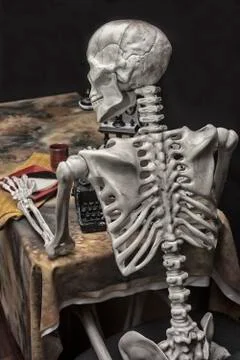 Human Halloween Skeleton at the table with typwriter Stock Photos