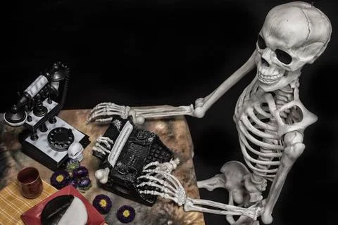Human Halloween Skeleton at the table with typwriter Stock Photos