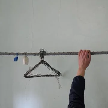 Human hand and rusty wire hangers in abandoned house Stock-Fotos