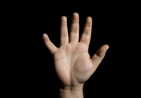 A human hand on a black background Stock Photos