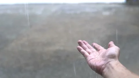 Human hand catching rain drops during rainy season. Stock Footage 130773925